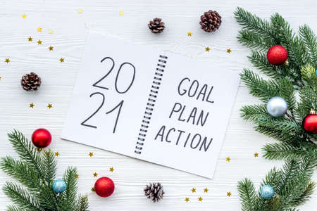 2021 New Year goals and plan with Christmas decorations and gift box. Overhead
