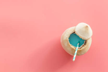 Fresh fruit drink in coconut with straw, top viewの写真素材