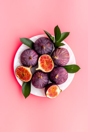 Fresh ripe figs in on plate with leaves. Mediterranean fruit background