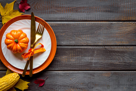 Thanksgiving day dinner table, top view . Autumn vegetables on plate with cutlery