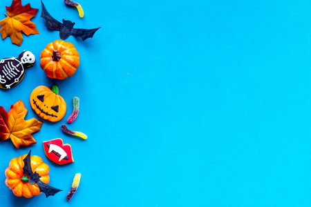 Halloween background concept - gingerbread cookies and candies, top view