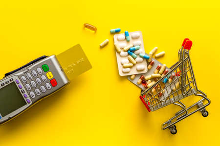 Healthcare costs and fees - payment terminal with a bank card, top viewの写真素材