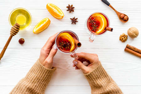 Female hands holding glass with mulled wine - Christmas hot drinkの写真素材