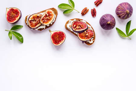 Sandwiches with figs, cheese and honey on tableの写真素材