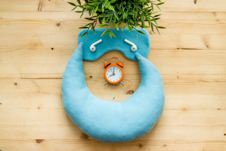 Sleep disorder stress concept. Sleeping mask with alarm clock, flat lat,top view