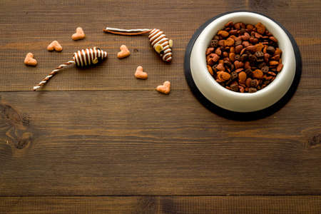 Dry cat food in bowl with toy, top viewの写真素材