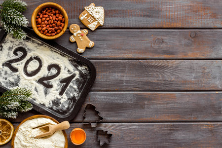 Flat lay of Christmas cooking with icing gingerbread cookies, top view