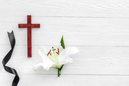 White lily with cross and black ribbon. Funeral conceptの写真素材