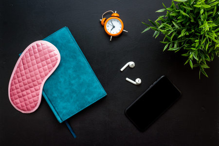 Reading book before going to bed. Sleeping accessories on the table, top view