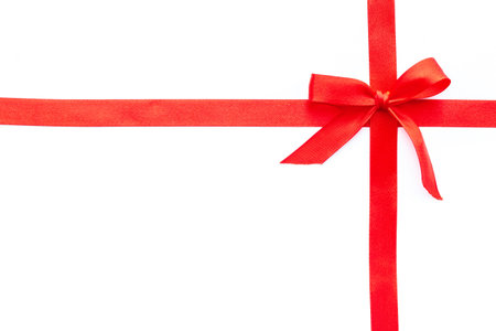 Red ribbon bow on white background, top view, copy space