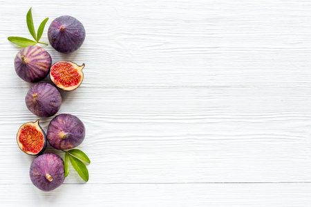 Fresh purple fig fruit with leaves. View from aboveの写真素材