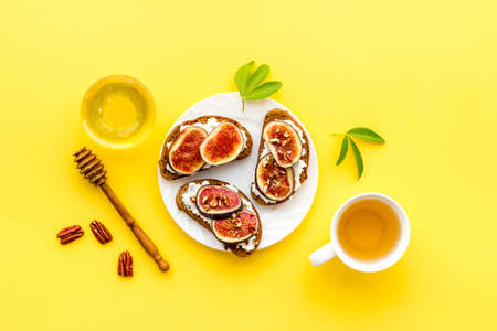 Sandwiches with figs, cheese and honey on plateの写真素材