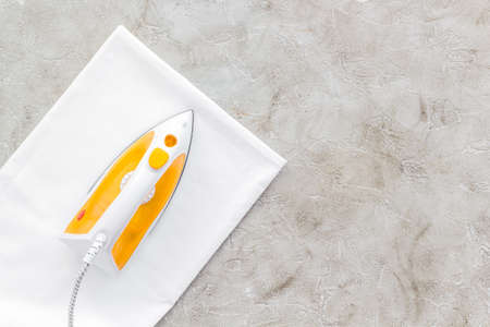 Household laundry ironing concept. Iron with clothes top viewの写真素材