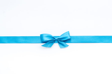 Blue ribbon with bow isolated on white for gift box. Top view, copy spaceの写真素材