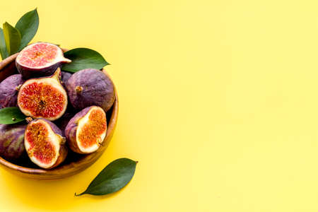 Fresh ripe figs in a bowl with leaves. Mediterranean fruit backgroundの写真素材