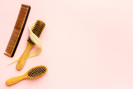 Female blond hair wirh bamboo brush, flat lay