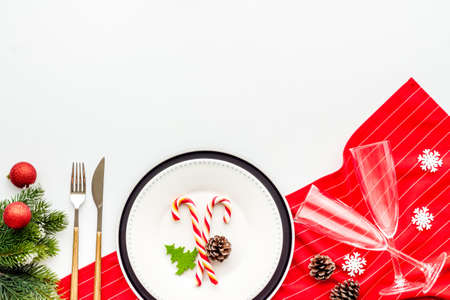 Christmas dinner concept with empty plate and glasses. Top view, flat layの写真素材