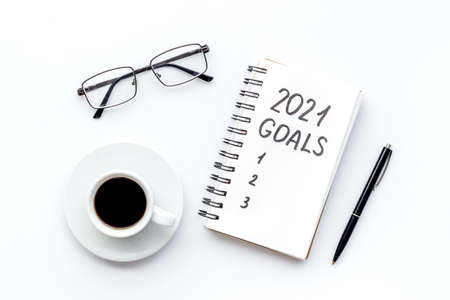 New year goals list. Christmas decorations and notebook on a table, flat layの写真素材