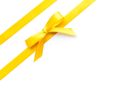 Golden ribbon with bow isolated on white. Top viewの写真素材