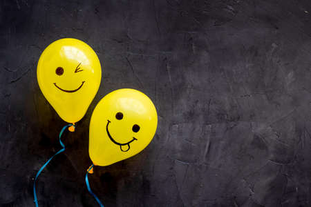 Positive emotions set. Happy and winking emoticons painted on colored balloonsの写真素材