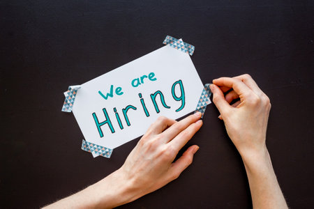 We are hiring - job recruting concept. Words We are hiring on paper bannerの写真素材
