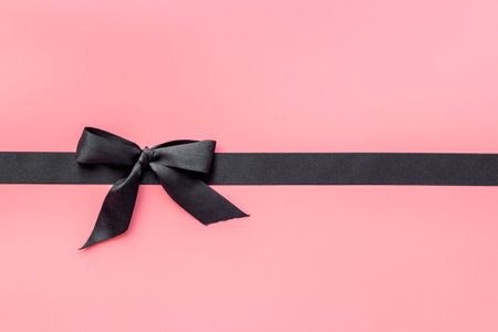 Black ribbon with bow for holiday gift box. Top view, copy spaceの写真素材