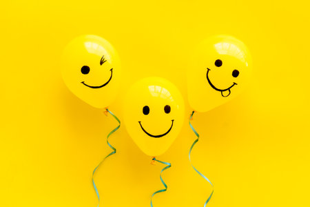 Positive emotions set. Happy and winking emoticons painted on colored balloons.の写真素材