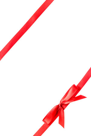 Red ribbon with bow isolated on white. Top view. Copy spaceの写真素材