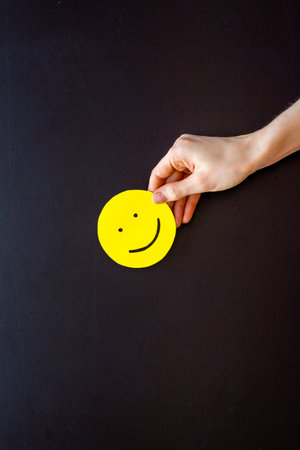 Smiling face emotion concept. Smile face on paper banner, top viewの写真素材