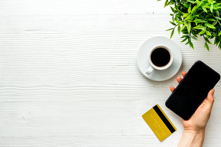 Payment technology concept. Mobile phone with credit card, top view