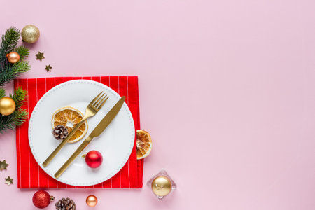 Top view of Christmas table place setting with empty plate and festive decorationsの写真素材