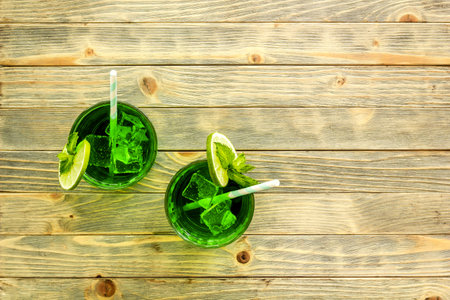 Glasses of iced mojito or lemonade with lime and mintの写真素材
