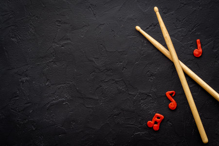 Drum sticks with music notes, overhead view. Music background