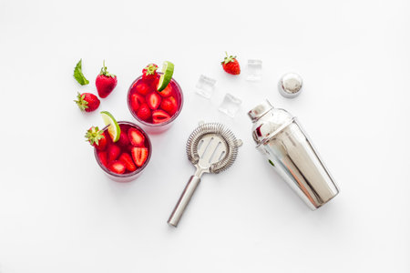 Red drink coktail with strawberry, ice and mint. Cocktail making bar toolsの写真素材