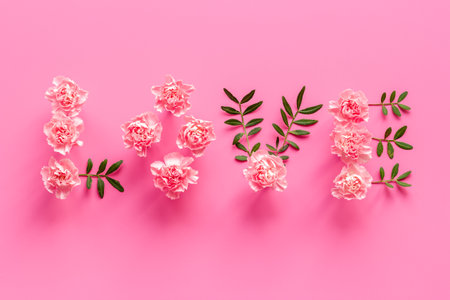 Word Love for greeting card of flowers and leaves. Top viewの写真素材