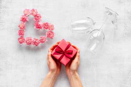 Red gift box in womans hands - Valentines Day celebration. Top viewの写真素材