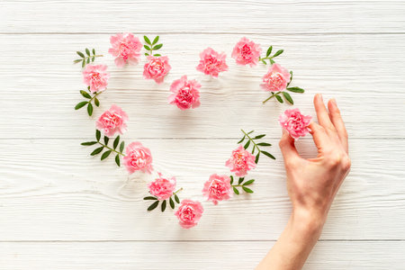 Heart shape of pink flowers. Valentines Day, wedding or birthday backgroundの写真素材