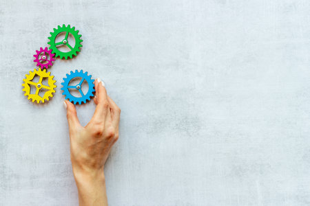 Working gears mechanism in hand. Teamwork concept. Top viewの写真素材