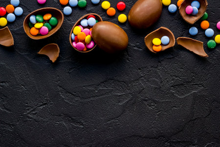 Happy Easter flat lay of chocolate eggs and sweets, top view