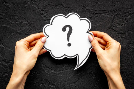 Question mark on speech bubble in hands. FAQ or search informationの写真素材