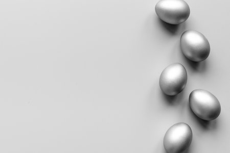 Silver Easter eggs on blue background. Top view decorationの写真素材