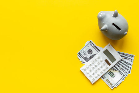 Piggy bank with cash money and calculator. Saving money concept