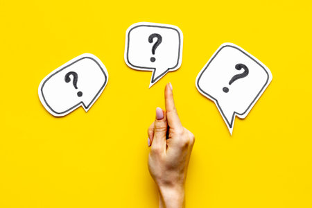 Question mark on speech bubbles with hand, top view. Solution conceptの写真素材