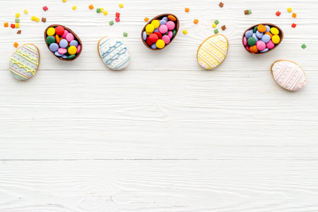 Top view of Easter cookies eggs and sweets. Space for text