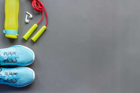 Flat lay of fitness gym equipment with sneakers and bottle of waterの写真素材
