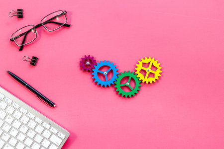 Business process and teamwork concept - working gears on office table, top view