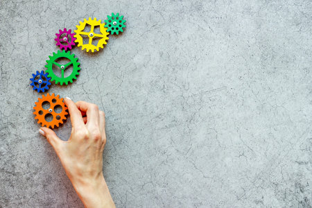 Working gears cogwheels mechanism in hand. Business problem solution and teamwork concept