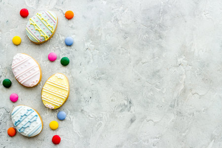 Top view of Easter cookies eggs and sweets. Space for text