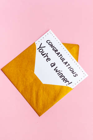 Congratulations award concept -You are a winner card in golden envelopeの写真素材