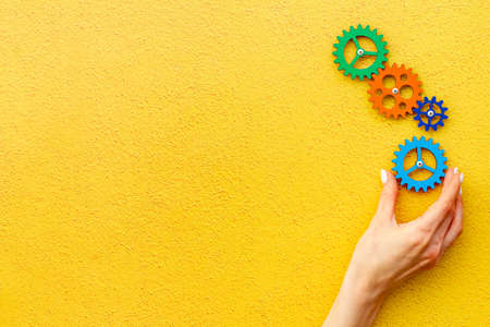 Working gears cogwheels mechanism in hand. Business problem solution and teamwork conceptの写真素材